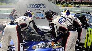 Jimmie Johnson's pit crew works on his car during the Sunoco Red Cross Pennsylvania